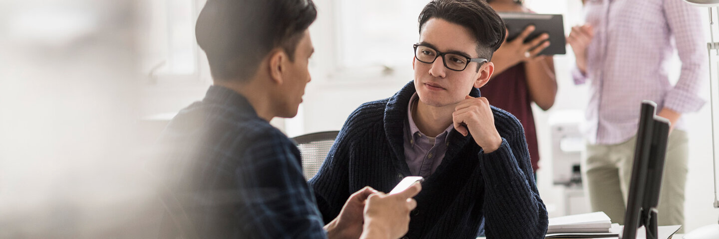 Social media managers reviewing social media on iphone and tablet.