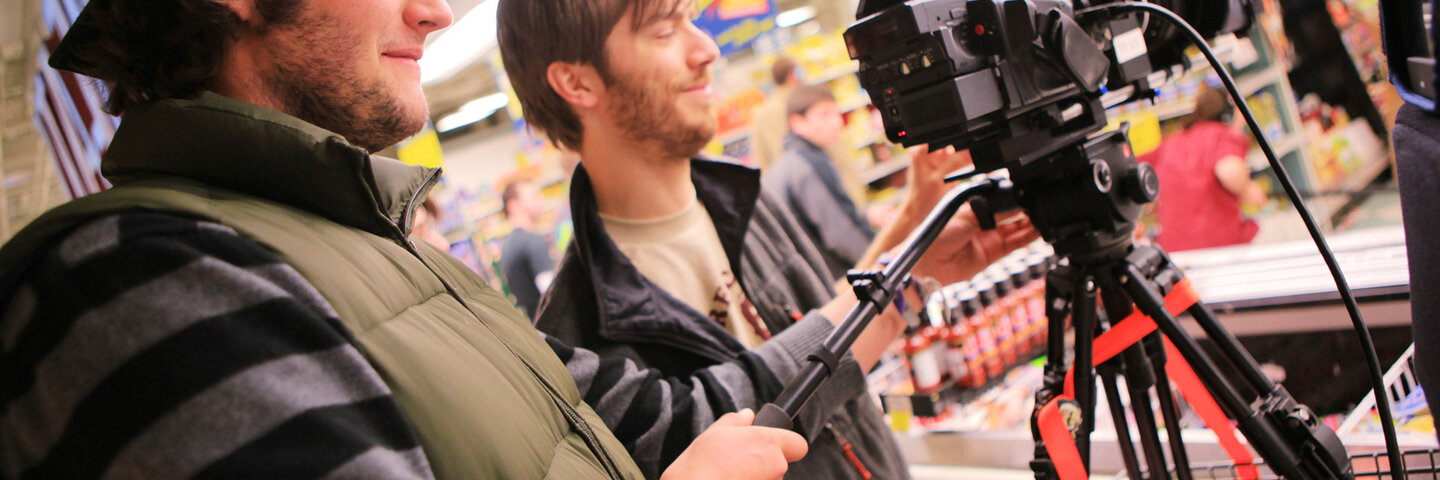Two cinematographers using a camera