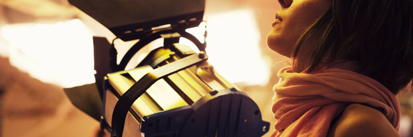 Filmmaker Adjusting Light