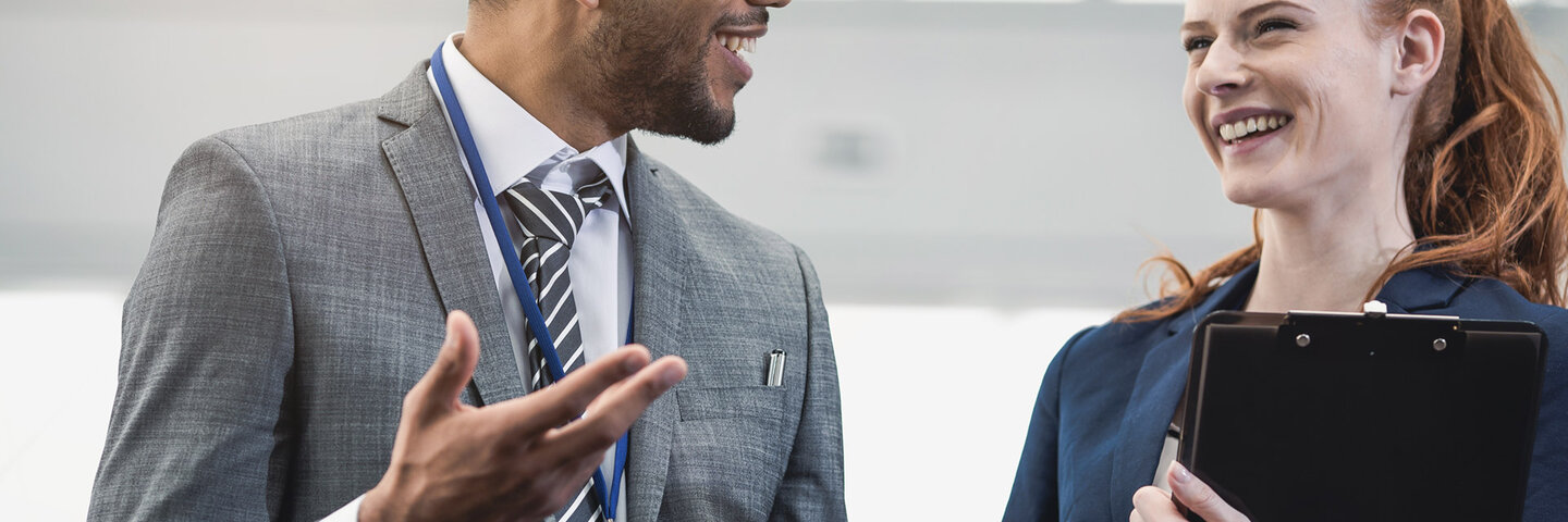 man and woman talking in office