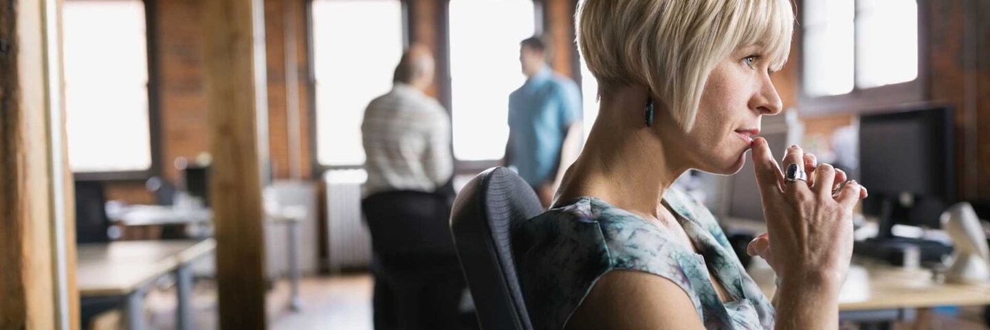 Woman contemplating in office.