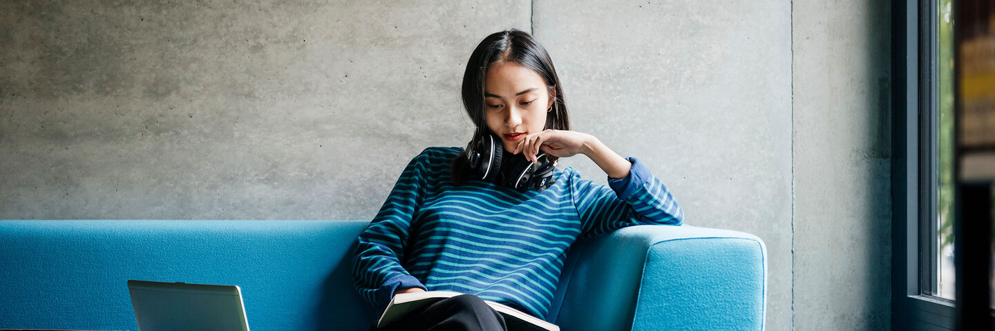 woman studying on the library sofa