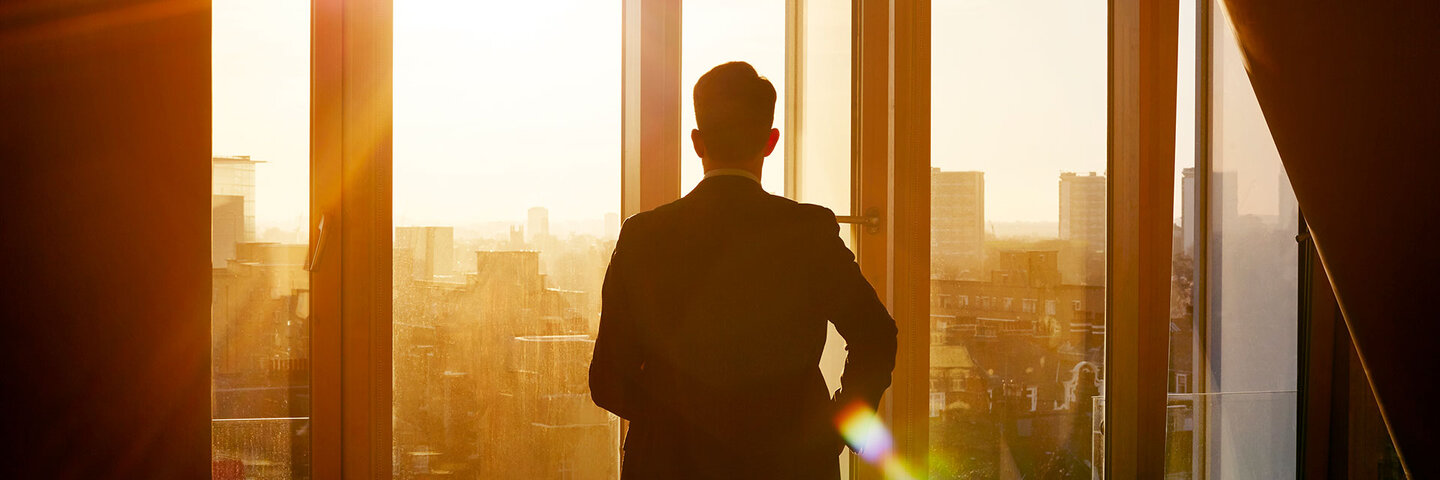 Business man walking toward the light