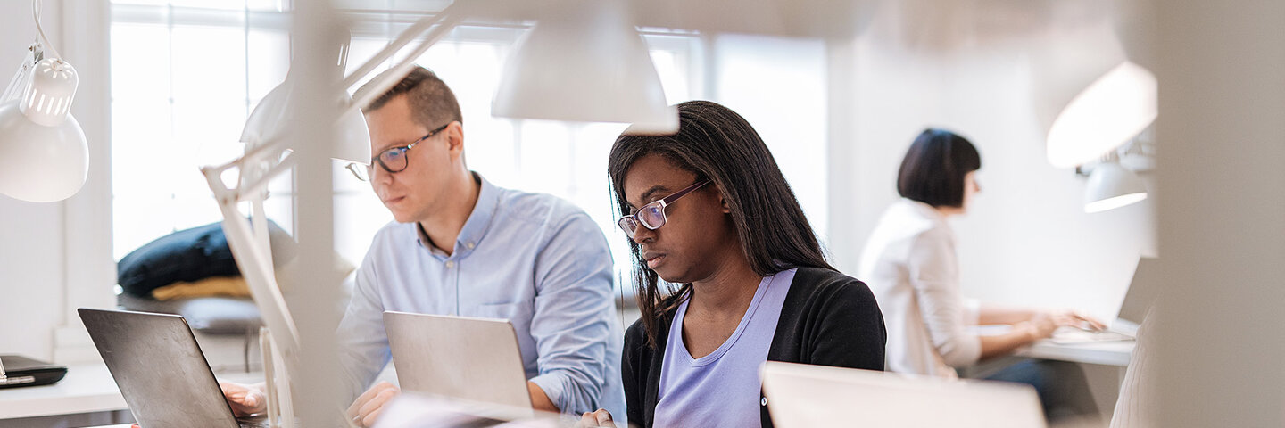 Journalists working together in the newsroom