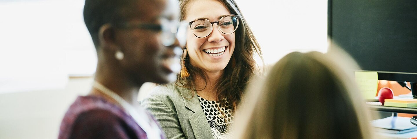 women in a group smiling candidly
