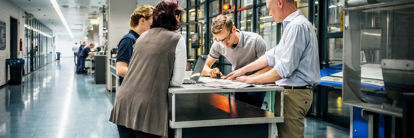 Staff meeting close to a production line