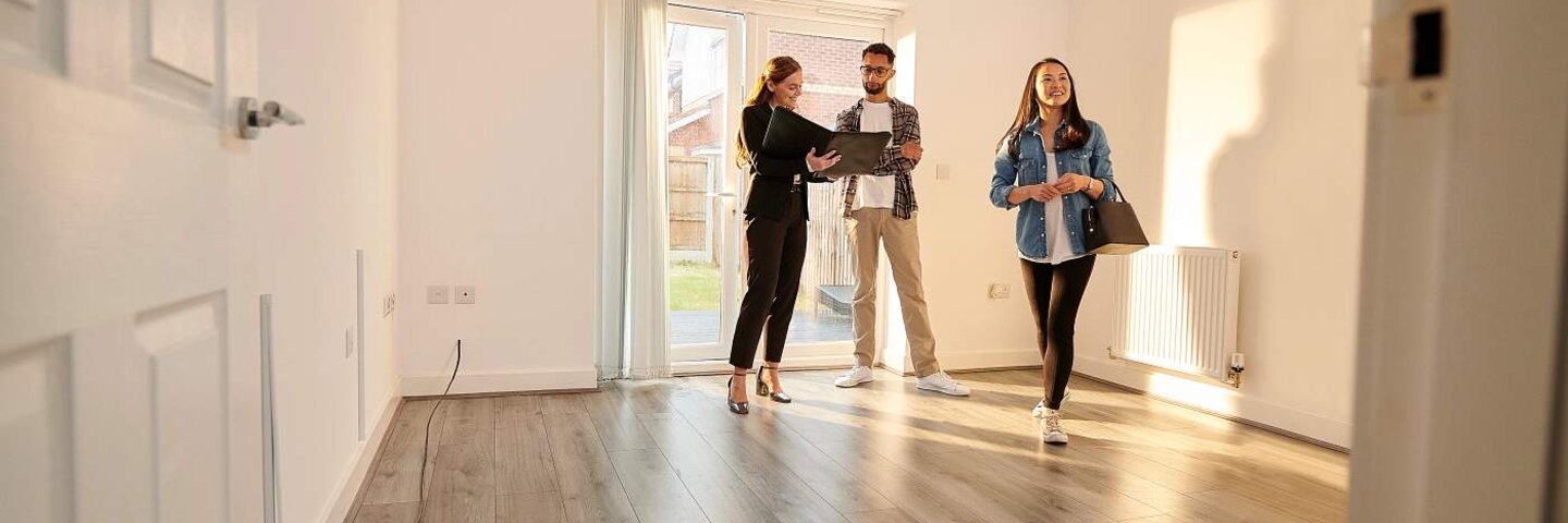 Real estate agent showing investors interior of property