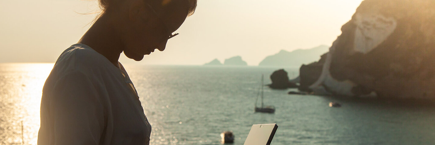 woman writing by the sea