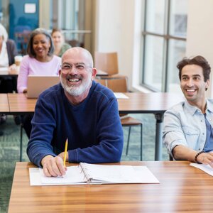mature man smiling in classroom